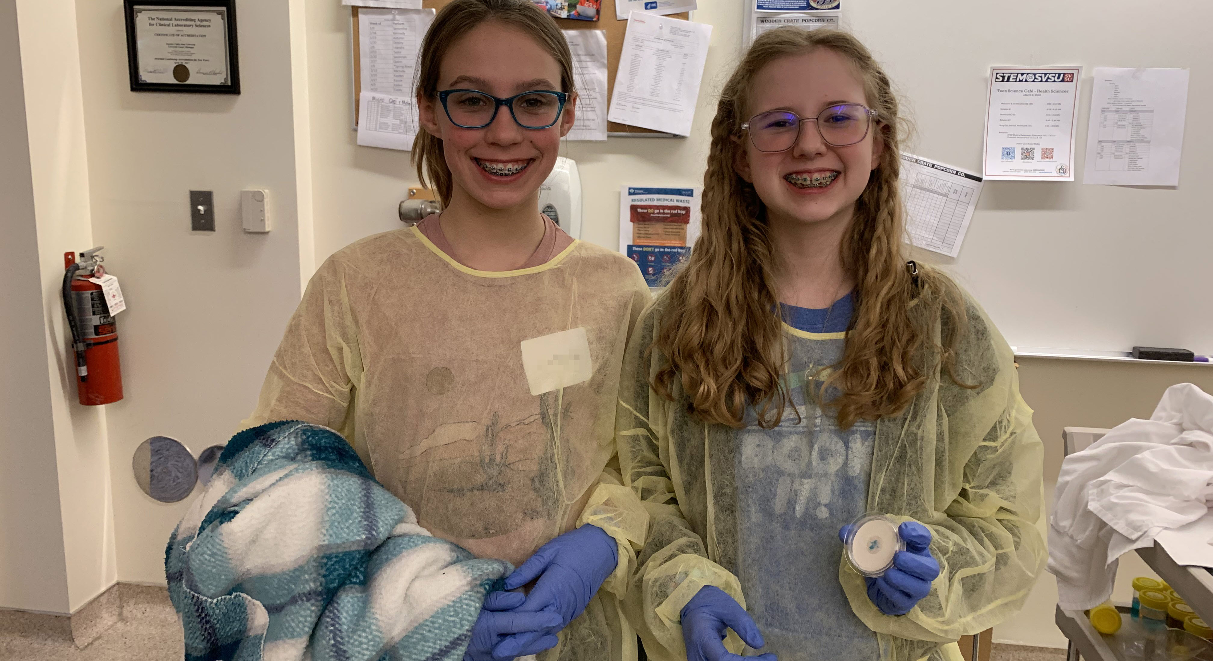 Students displaying a Petri plate.